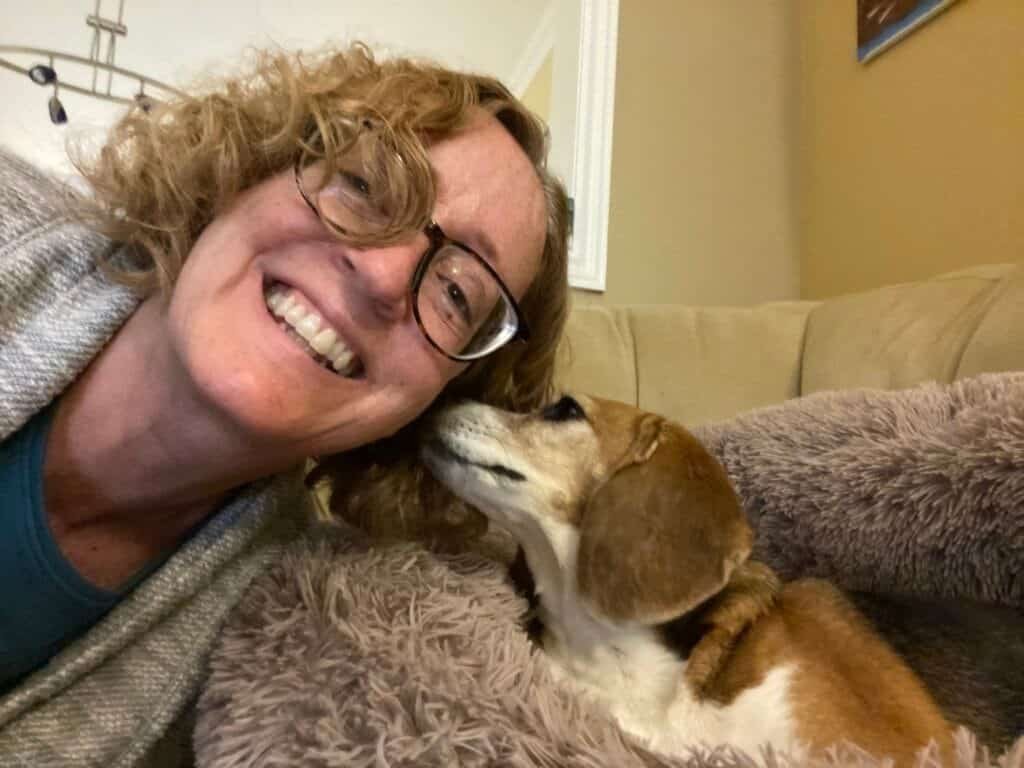Woman being licked on the face by a dog