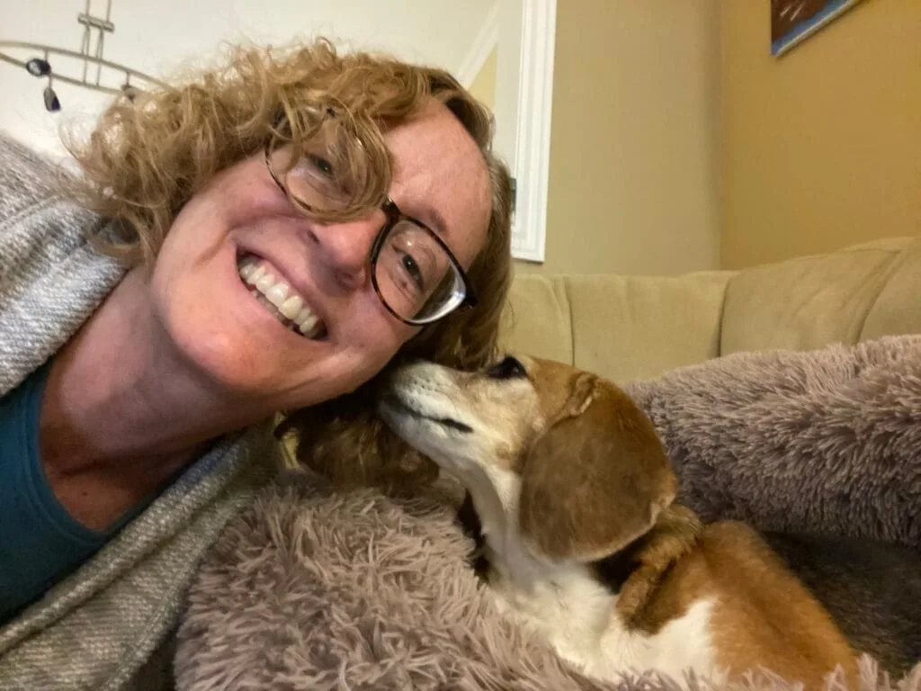 Woman being licked on the face by a dog
