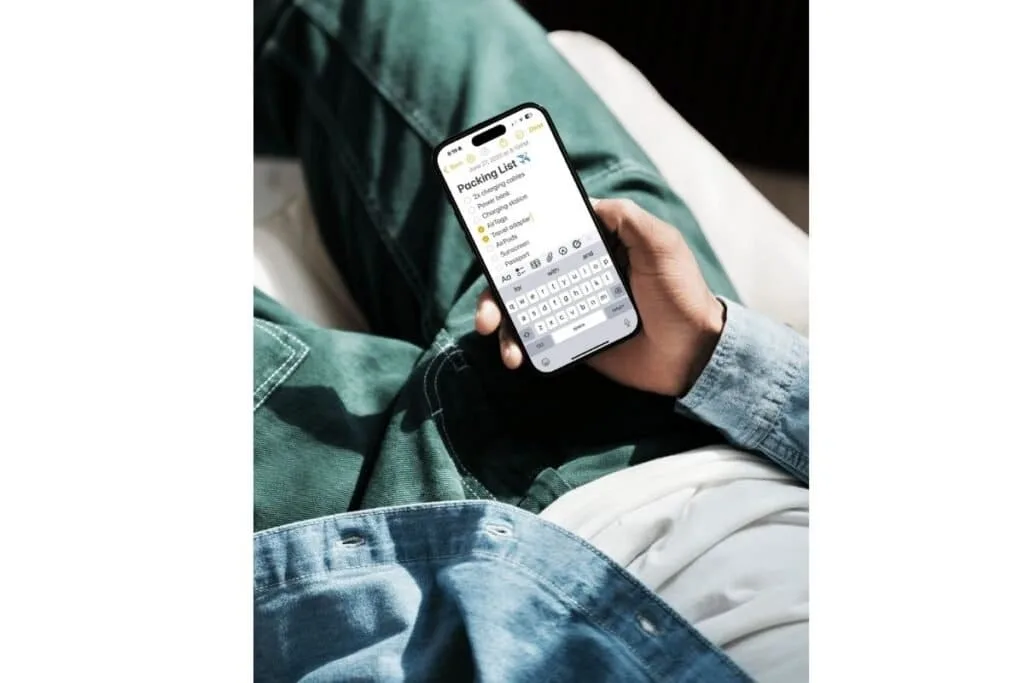 iPhone Tips for Travel showing someone using the notes app for a packing list.