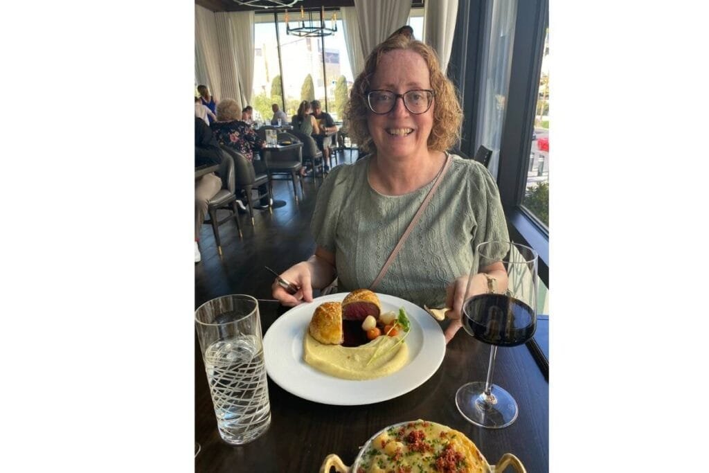 Indoor Window Pic Photo of woman sitting by a window in a restaurant as an example of photo taken with natural indoor light.