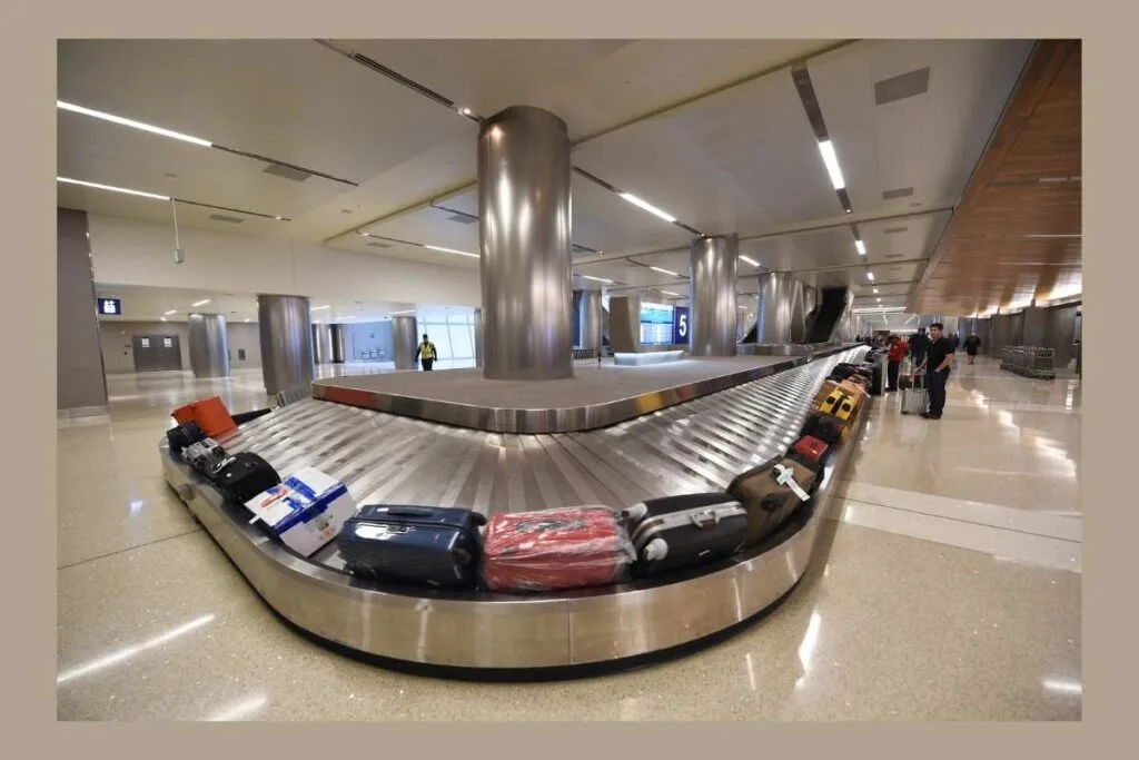 Ways to use AirTags on Luggage Airport luggage carousel filled with bags as an example of ways to use an AirTag to track luggage.