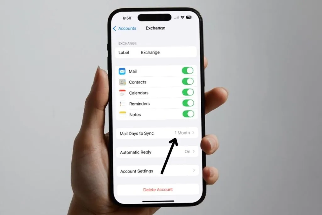 Hand holding an iPhone showing the setting page for Exchange mail with an arrow pointing to the Mail Days to Sync option on the screen.