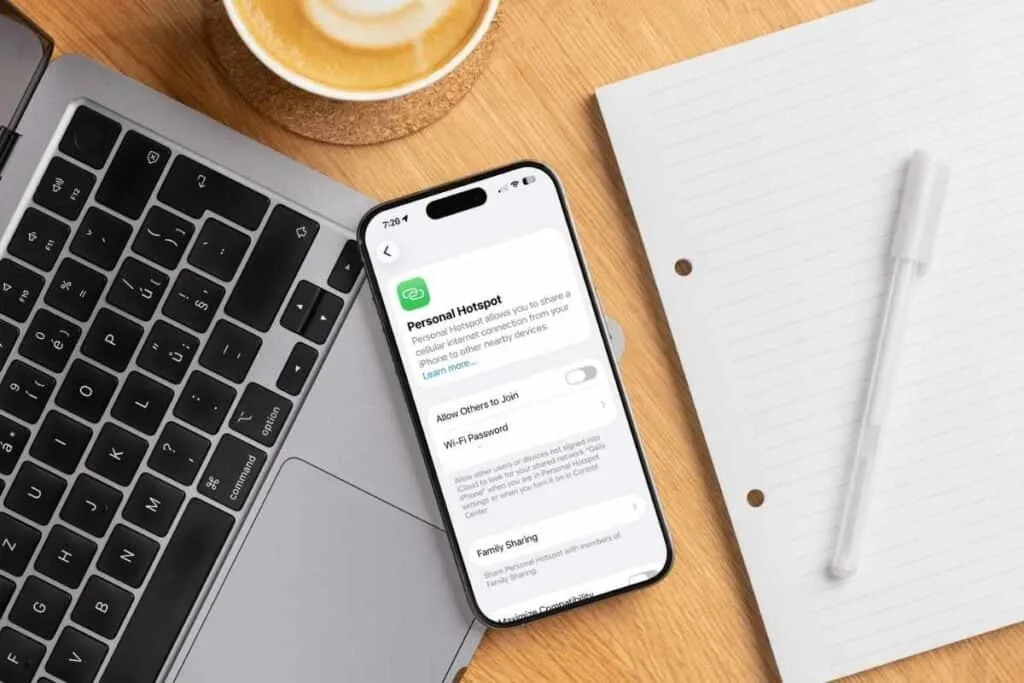 iPhone screen with personal hotspot on the screen and a laptop next to the iPhone as an example of what is an personal hotspot on iPhone .