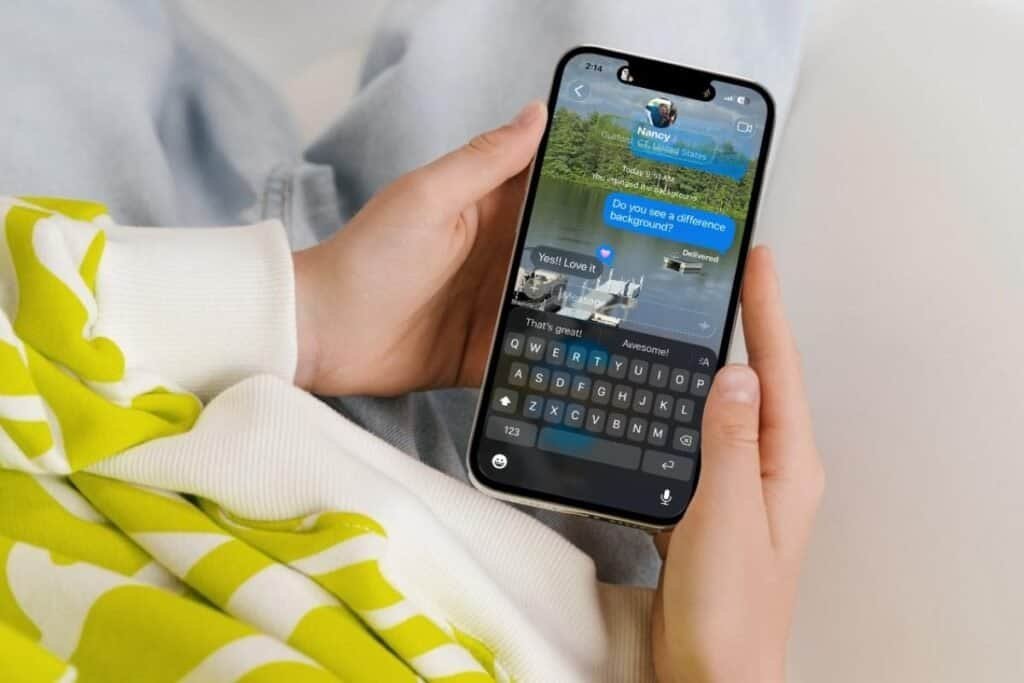 iPhone screen in hand showing messages screen with a changed background.